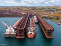 Indiana Harbor loading ore far left, Presque Isle in the middle and Arthur M Anderson on the right waiting their turn in Two Harbors. On the far far right that tiny little red and yellow boat is the museum tug Edna G. David Schauer (Oct 2021)